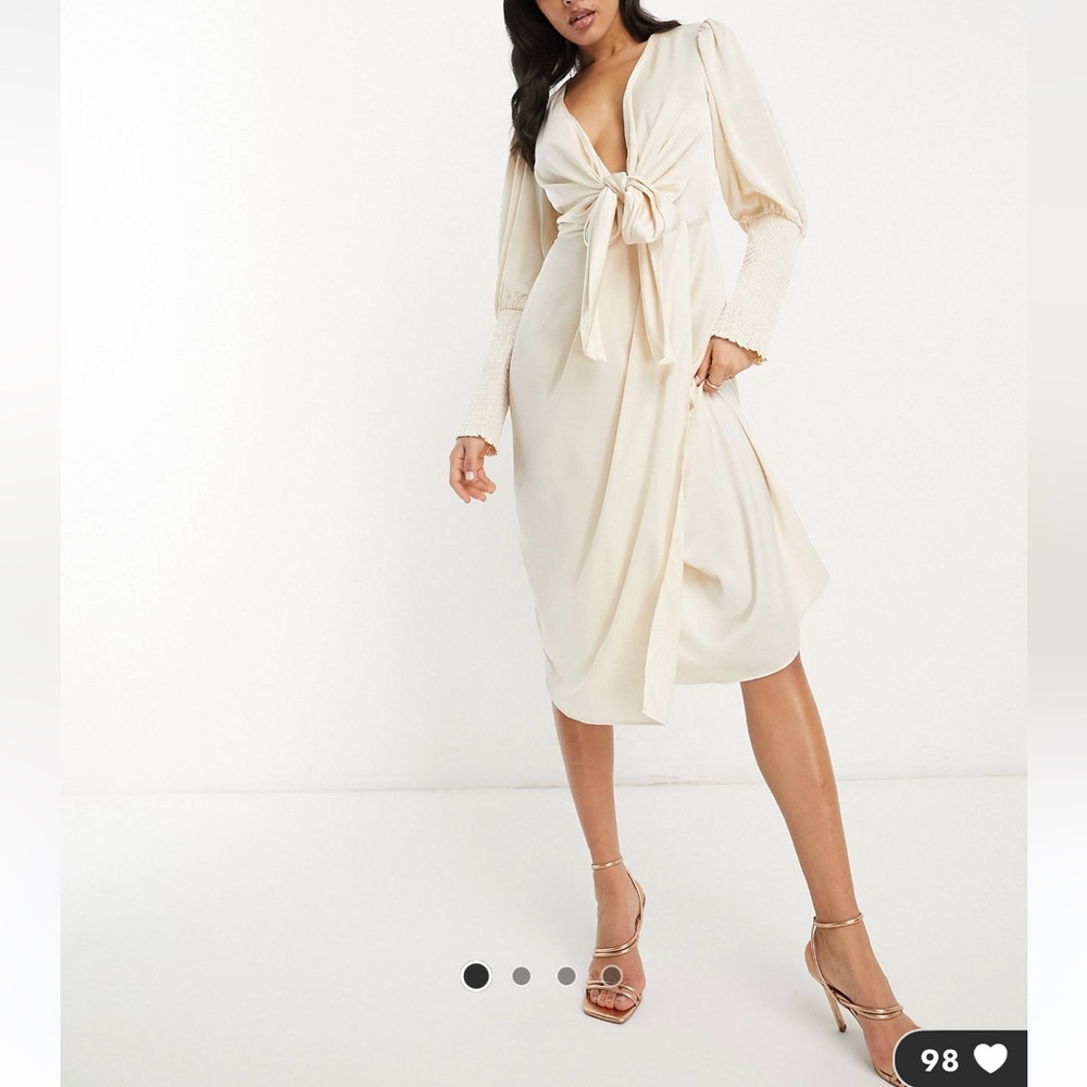 A cream silk midi bow tie dress. Worn a few times and light weight.
